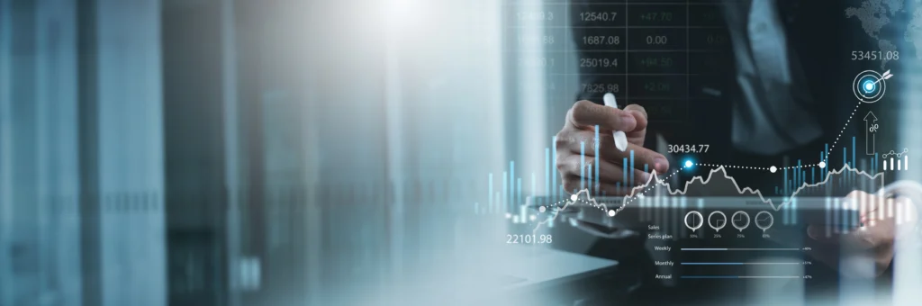 Financial charts and forecast figures above a desk in an office